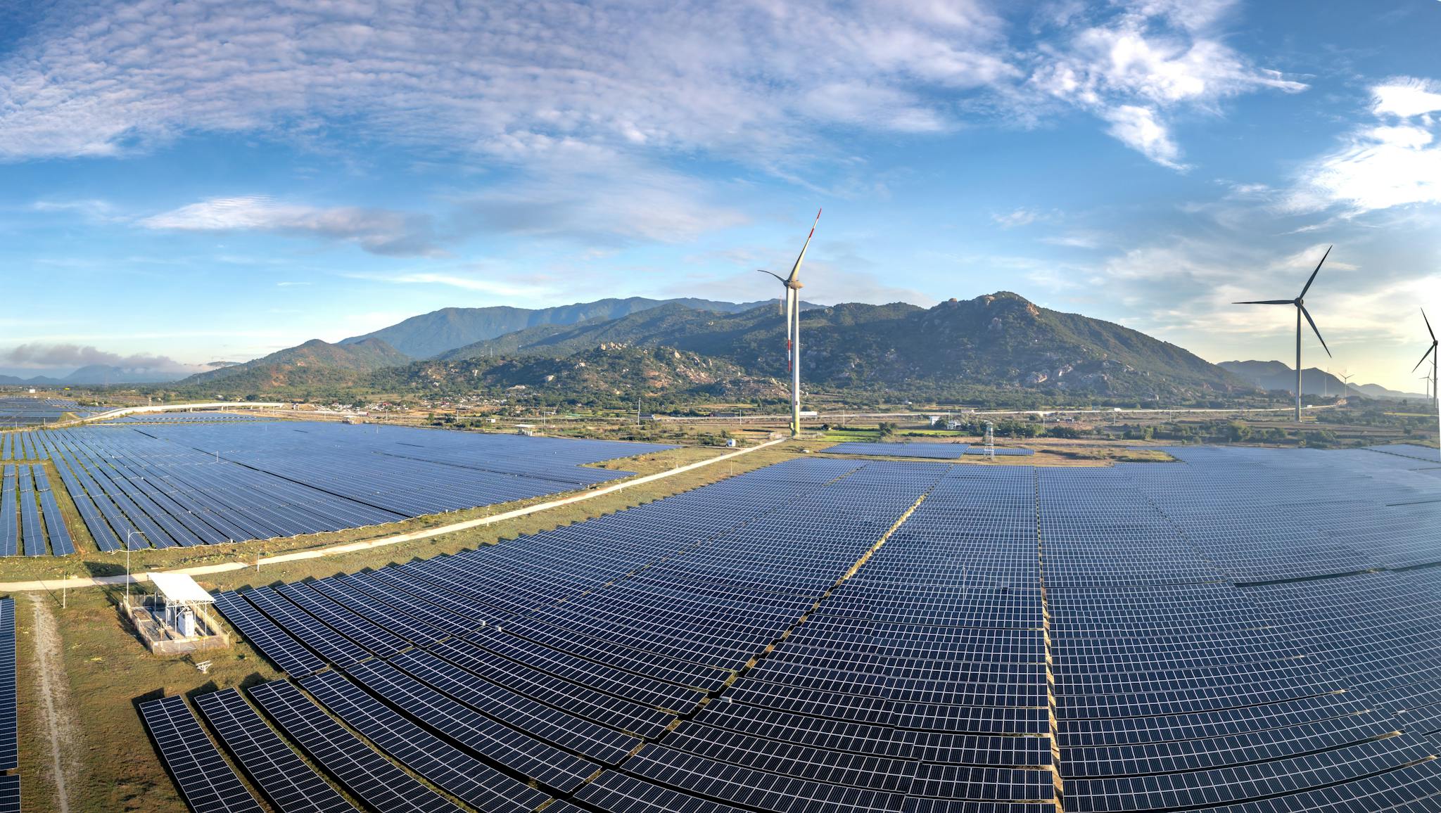 Aerial view of solar panels and wind turbines in Ninh Thuan, Vietnam, showcasing sustainable energy solutions.